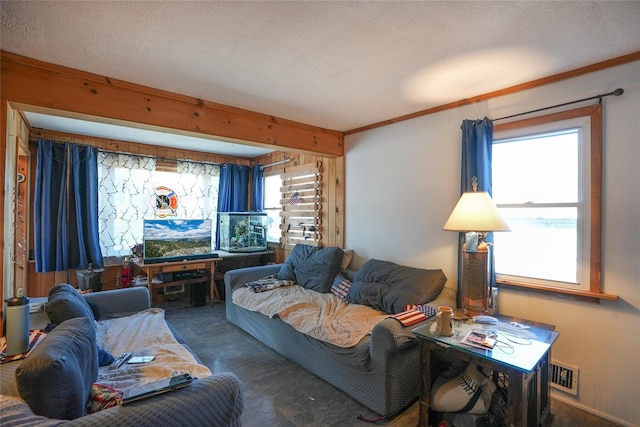 carpeted living room featuring beamed ceiling and a textured ceiling