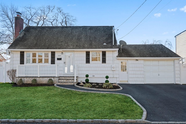 view of front of house featuring a porch, a garage, and a front yard