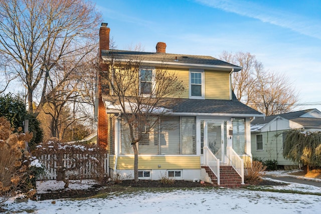 view of front of house featuring a sunroom