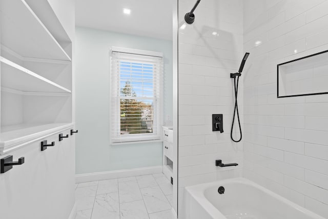 bathroom featuring vanity and tiled shower / bath