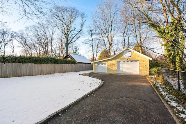 exterior space featuring a garage and an outbuilding