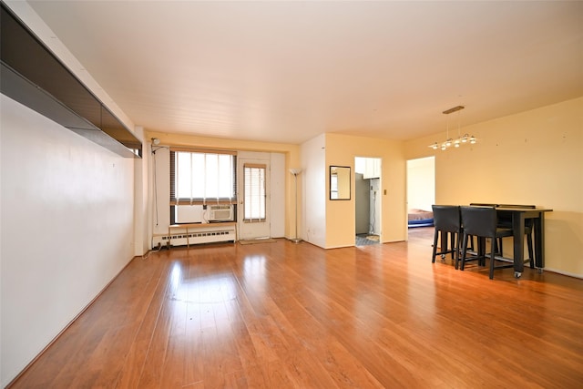 living room with light hardwood / wood-style flooring and a baseboard radiator