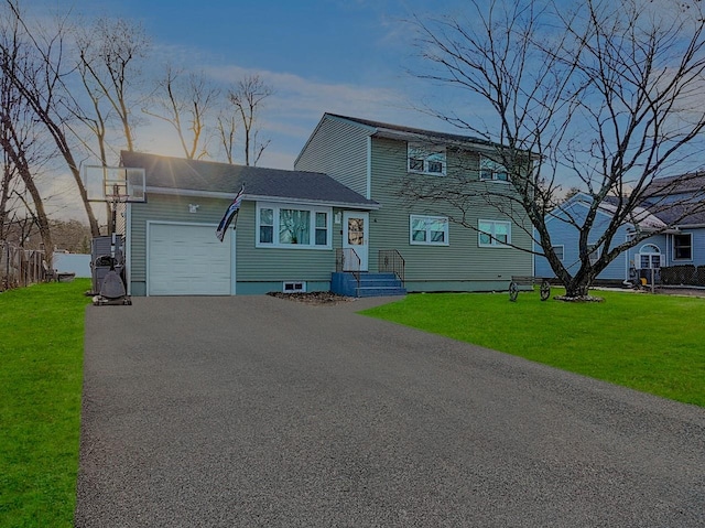 view of front facade with a garage and a front lawn