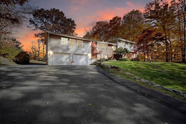 view of front facade featuring a lawn and a garage