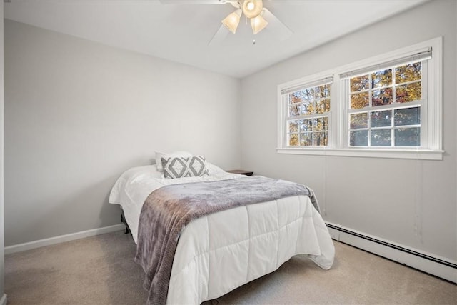 carpeted bedroom with a baseboard radiator and ceiling fan