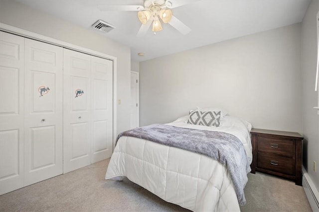 carpeted bedroom featuring ceiling fan and a closet