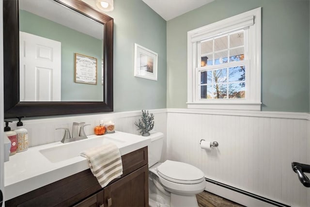 bathroom featuring vanity, toilet, and a baseboard radiator