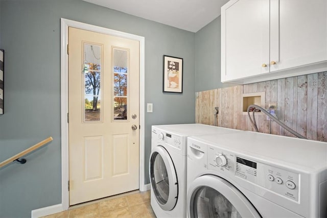 washroom featuring cabinets, light tile patterned floors, and separate washer and dryer