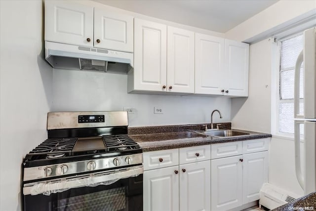 kitchen featuring white cabinets, stainless steel range with gas stovetop, and sink