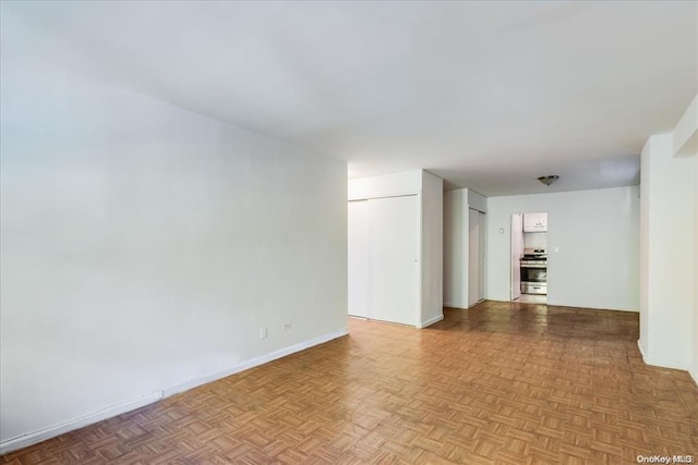 unfurnished room featuring light parquet flooring