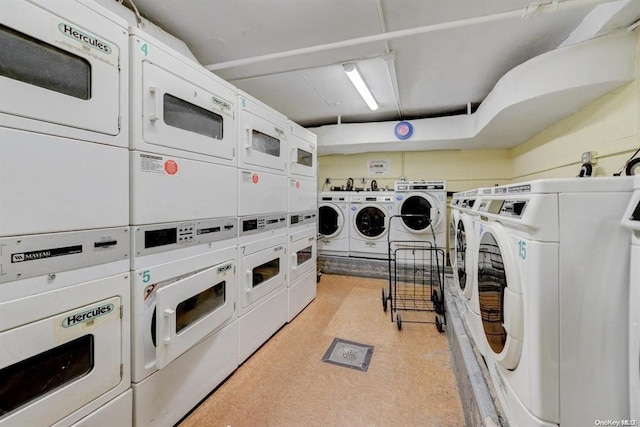 laundry area featuring washing machine and clothes dryer and stacked washer / dryer