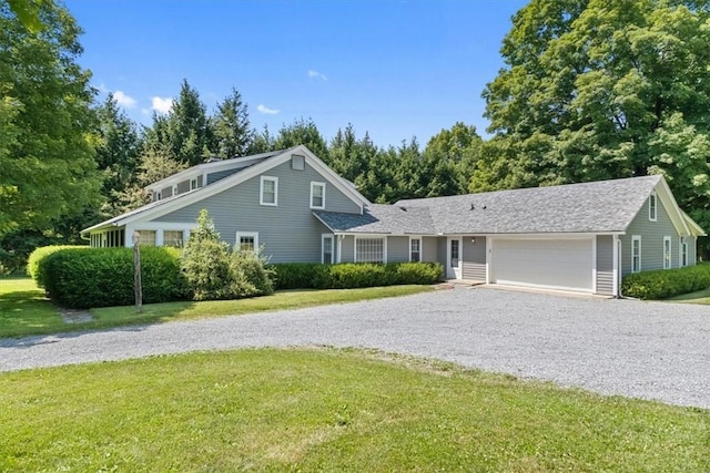 view of front of property featuring a garage and a front lawn