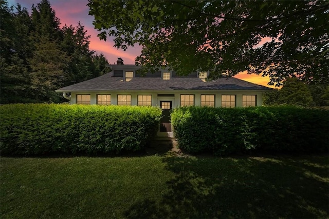 ranch-style house featuring a yard