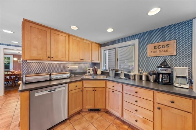 kitchen featuring light brown cabinetry, dishwasher, light tile patterned flooring, and sink