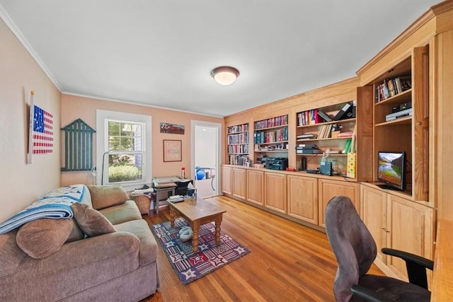 office area with built in features, light wood-type flooring, and crown molding