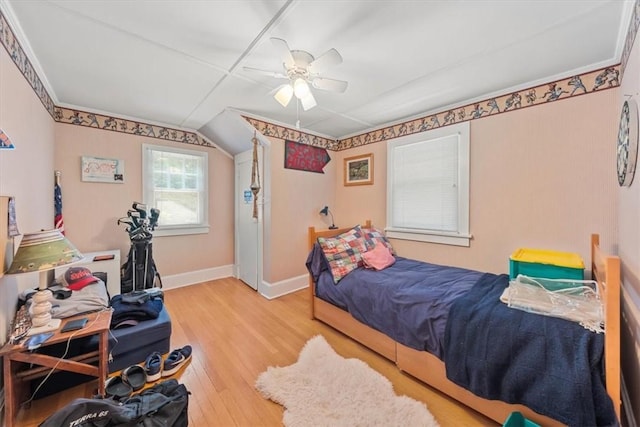 bedroom with light hardwood / wood-style flooring and ceiling fan