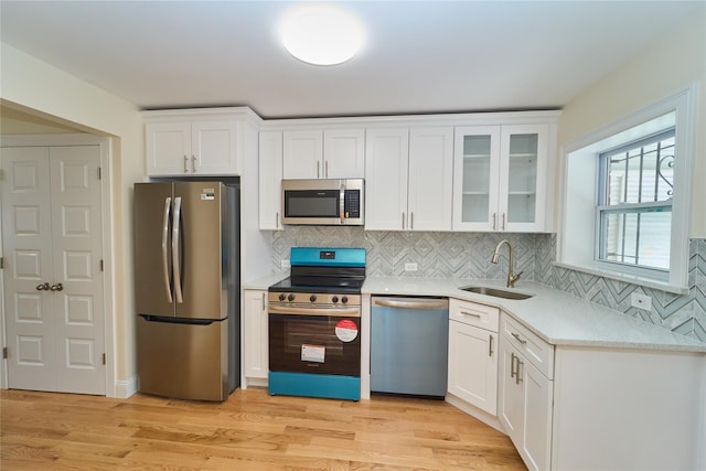 kitchen featuring white cabinets, sink, and stainless steel appliances