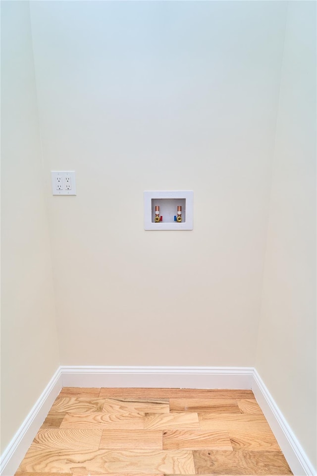 clothes washing area with hookup for a washing machine and wood-type flooring