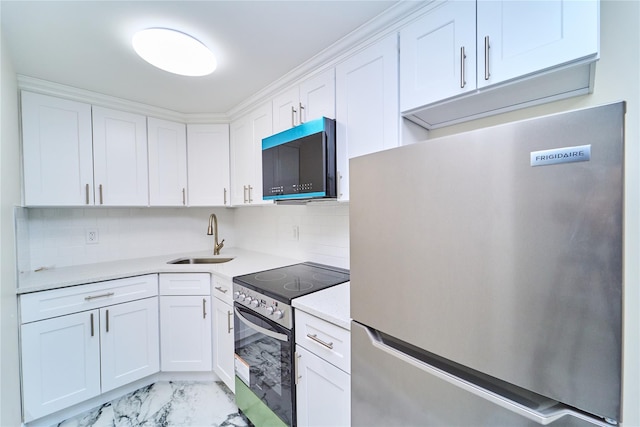 kitchen with decorative backsplash, white cabinetry, sink, and stainless steel appliances