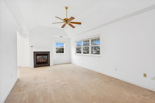 unfurnished living room featuring light colored carpet, vaulted ceiling, and ceiling fan