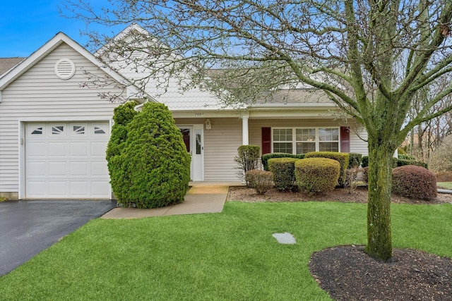 single story home featuring a front yard and a garage