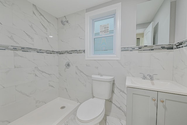 bathroom featuring a tile shower, vanity, toilet, and tile walls