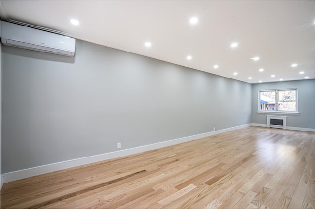 interior space with light hardwood / wood-style floors and a wall mounted AC