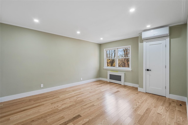 interior space featuring light hardwood / wood-style flooring and a wall mounted AC