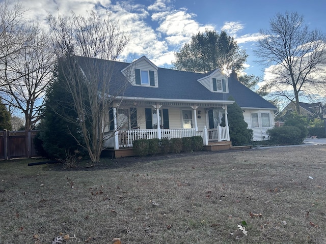 cape cod home featuring covered porch and a front yard