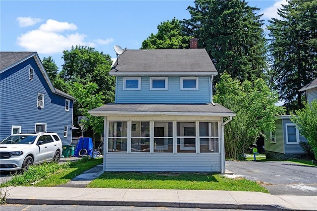 view of front of home with a sunroom