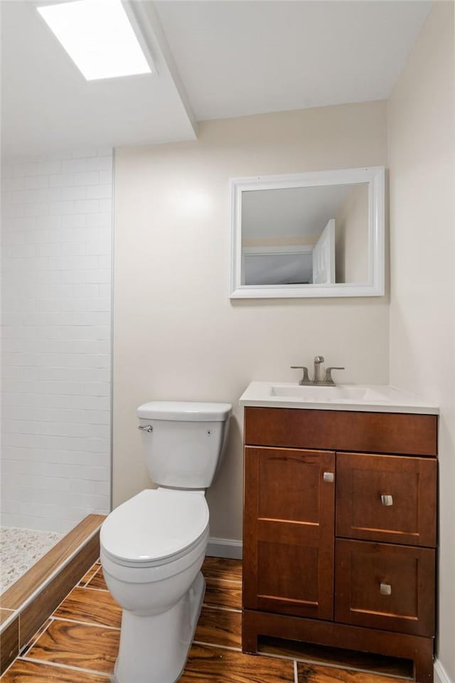 bathroom with walk in shower, toilet, vanity, and hardwood / wood-style flooring