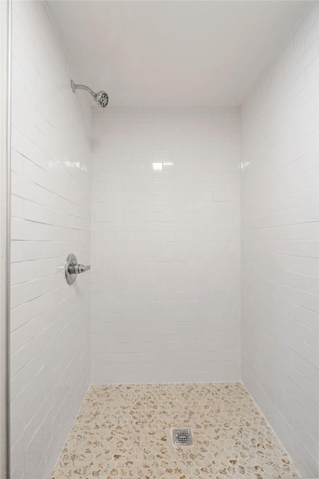 bathroom with a tile shower