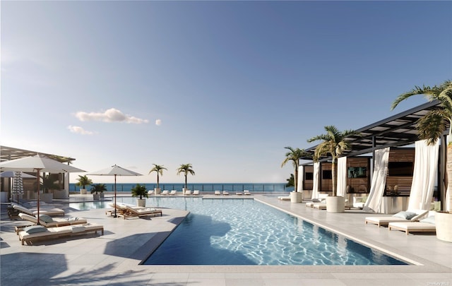 view of swimming pool with a patio and a water view