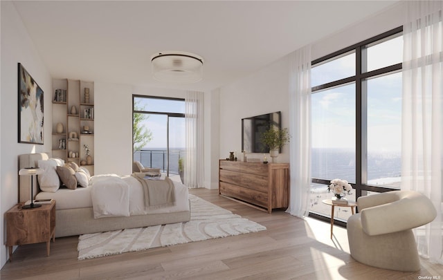 bedroom featuring access to exterior and light wood-type flooring