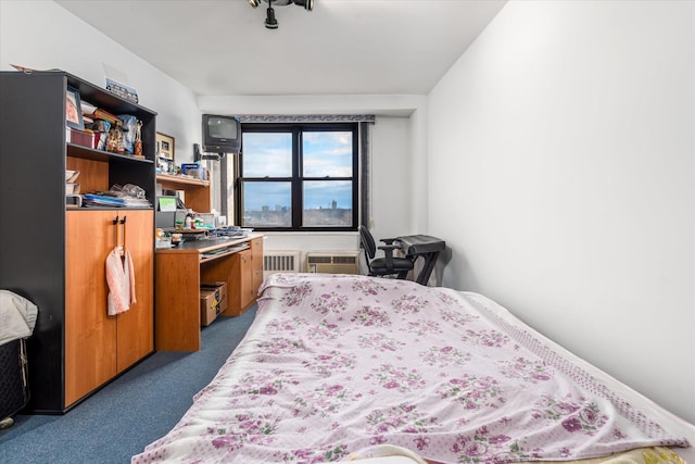 bedroom with radiator heating unit, carpet floors, and a wall mounted AC