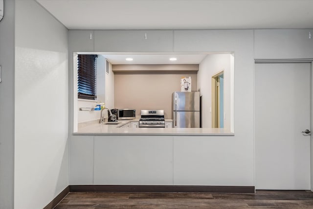 kitchen with sink, stainless steel appliances, and dark wood-type flooring