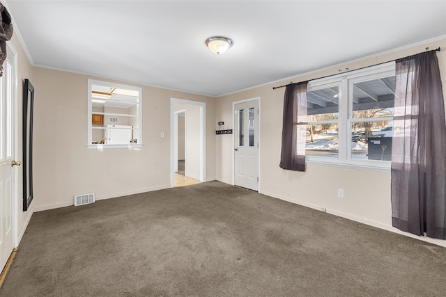 unfurnished room featuring dark colored carpet and ornamental molding