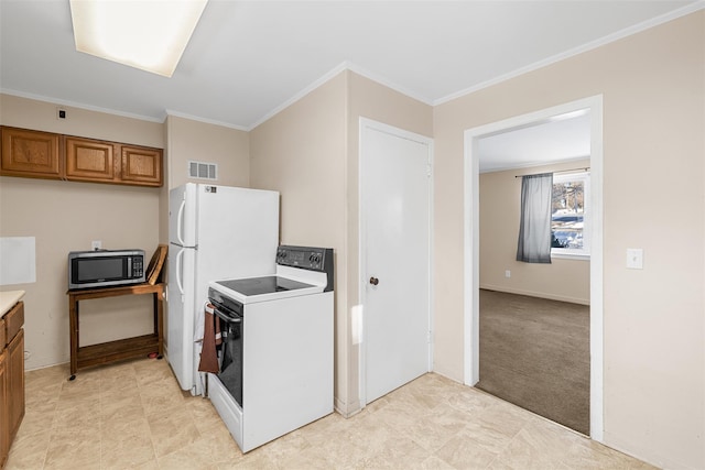 kitchen featuring light colored carpet, ornamental molding, and electric range