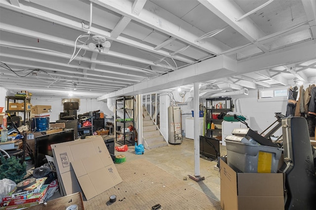 basement with gas water heater and washing machine and dryer