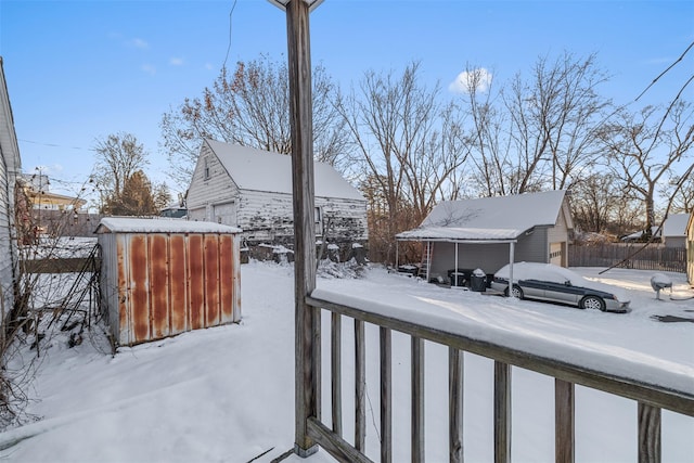 yard layered in snow featuring an outbuilding