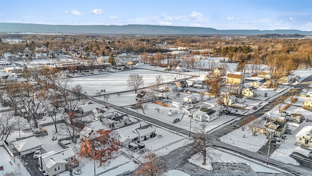 snowy aerial view featuring a mountain view