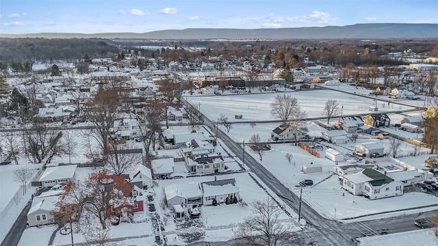 snowy aerial view featuring a mountain view