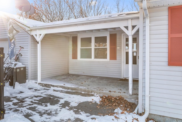 view of snow covered property entrance