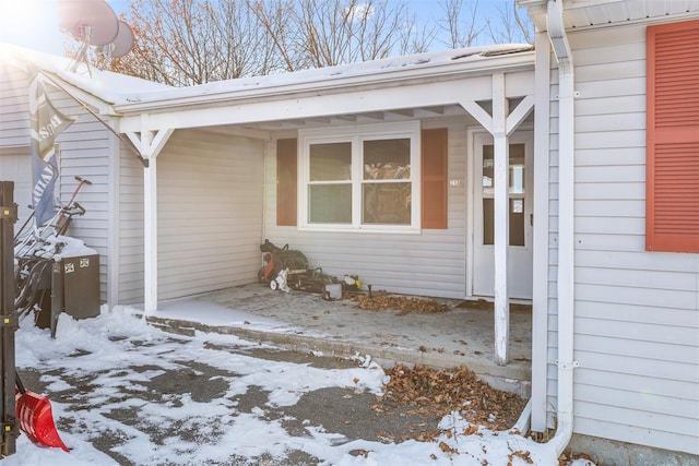 view of snow covered property entrance