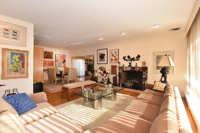 living room with a fireplace and light hardwood / wood-style flooring