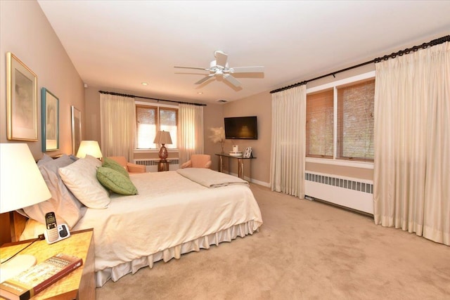 bedroom featuring radiator, ceiling fan, and carpet floors