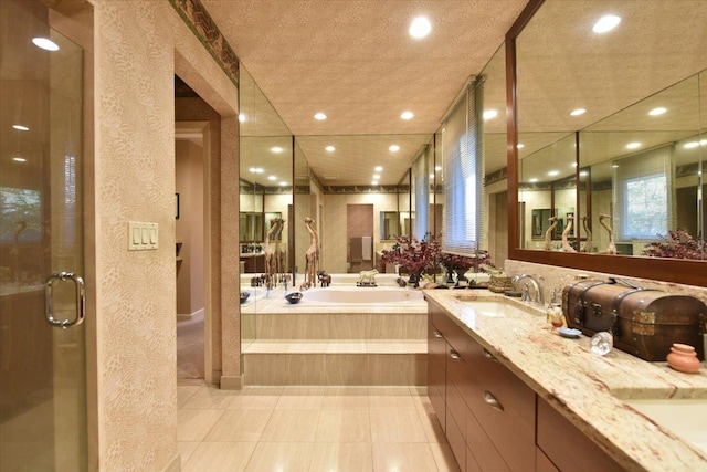 bathroom with plus walk in shower, vanity, and tile patterned flooring