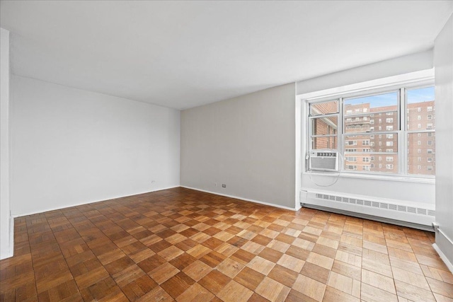 spare room featuring cooling unit and a baseboard heating unit