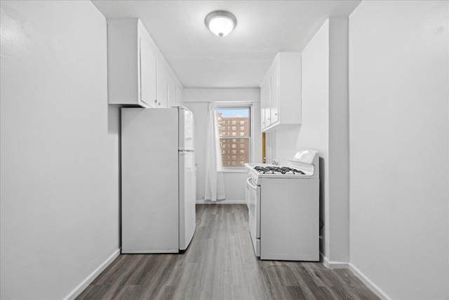 interior space featuring dark hardwood / wood-style floors, white cabinetry, and white appliances