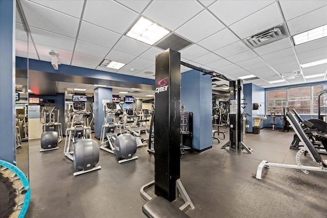 workout area with a paneled ceiling